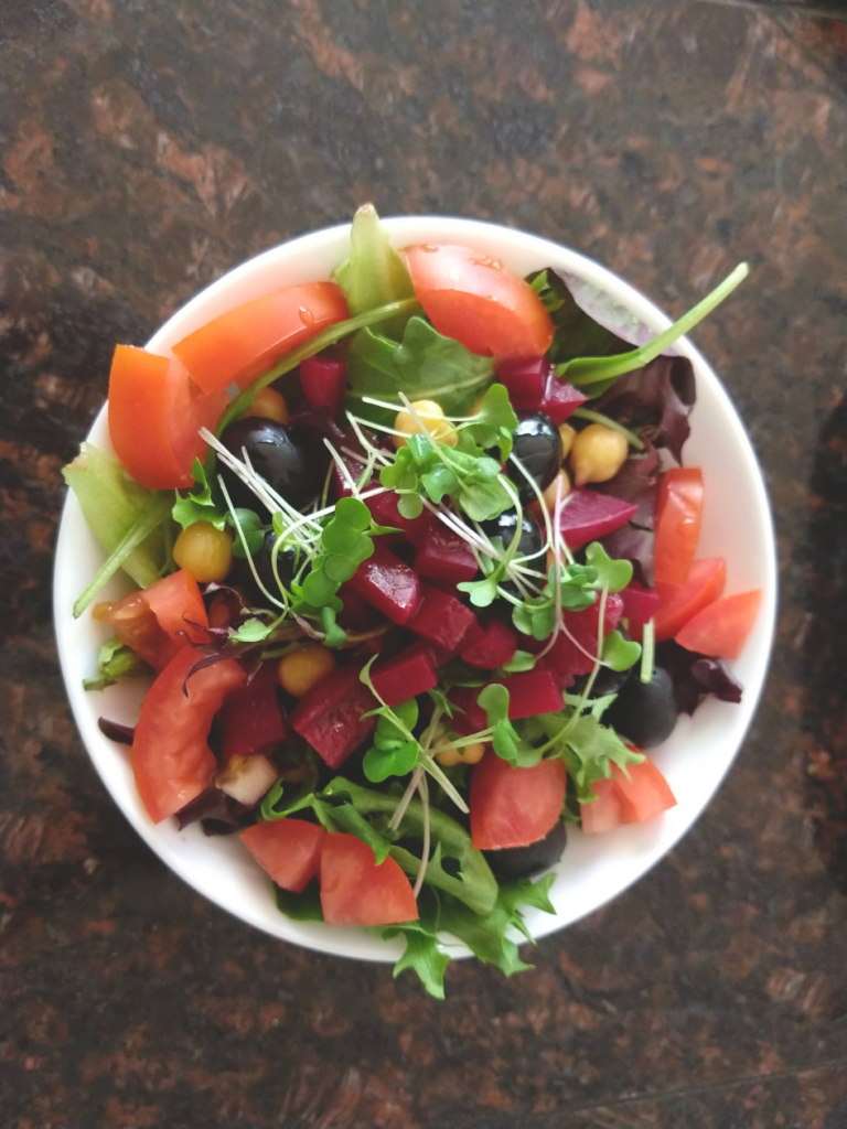 fruit salad garnished with green microgreens