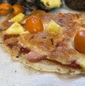 Close up of sourdough discard pizza crust with toppings